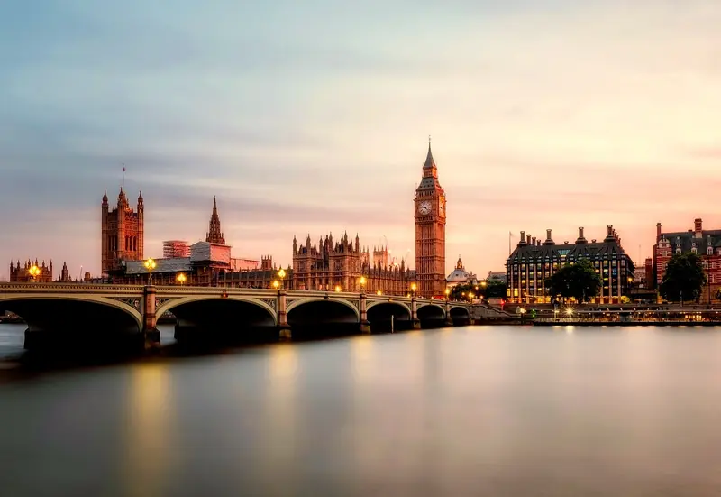 Big Ben and the Houses of Parliament beside the River Thames at dusk, London
