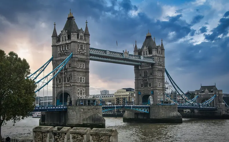 Tower Bridge spanning the River Thames under a dramatic evening sky, London