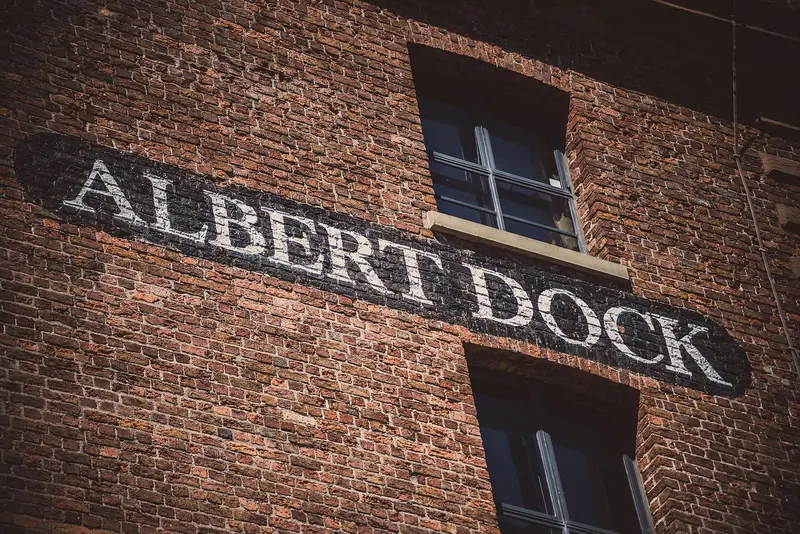 Historic Albert Dock signage on a brick warehouse wall, Liverpool